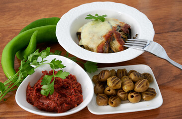 Stuffed zucchini with cheese green olives and red sauce