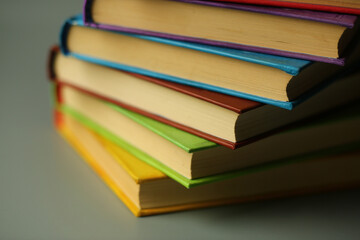 Close up of a book stack against grey background