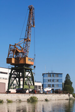 Port cranes work on the river coast