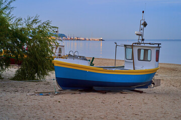 Naklejka na ściany i meble Picturesque fishing boat on beach in Sopot, Pomorskie region, Poland