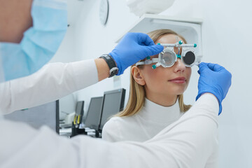 Eye Exam. Woman In Glasses Checking Eyesight At Clinic. Close-up Of Optometrist Checking Female...