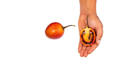 Ripe tropical tamarillo fruit in hands - Passiflora tripartita