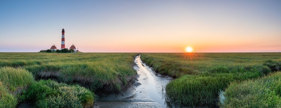 Westerheversand Lighthouse and Salzwiesen (salt marsh) at sunset, Westerhever, Nordfriesland, Schleswig-Holstein, Germany