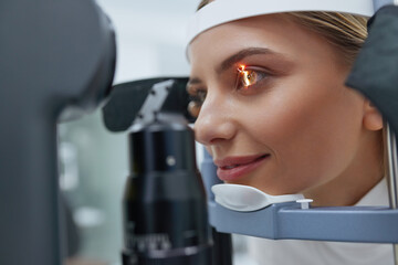 Eyesight Exam. Woman Checking Eye Vision On Optometry Equipment. Patient's Vision Check at...