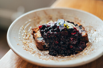 Sweet toast from homemade banana bread, non dairy yogurt and fresh berries compote