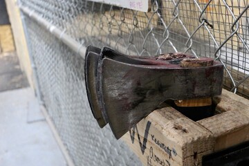 axe heads at chainlink fence