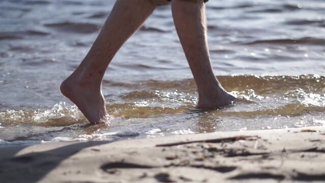 Close up of male feet walking on water on the beach.
Varicose veins on the leg of a man