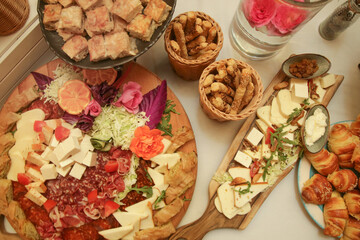 Buffet-style served meal with multiple hot and cold dishes of various foods on a table, directly above. Swedish table.
