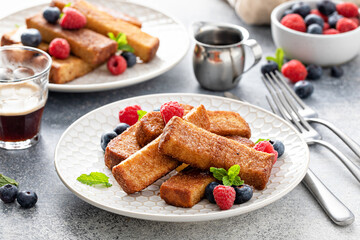 French toast sticks with maple syrup and berries