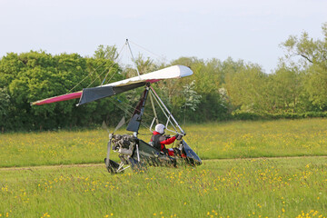 Ultralight airplane taxiing on a farm strip	