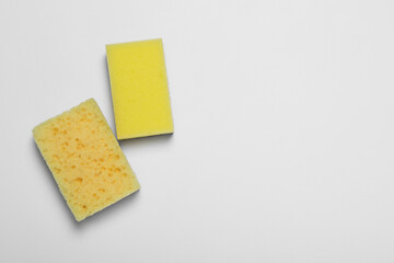 Sponges on white background, flat lay. Space for text