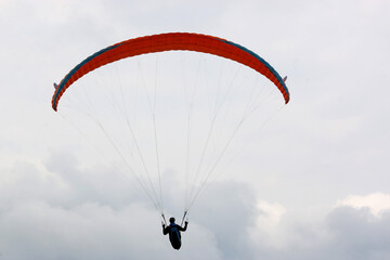 Paraglider in a cloudy sky	
