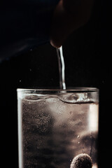 pouring water into glass