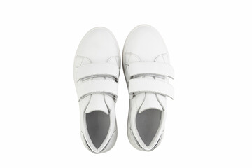 White leather sneakers with velcro in front instead of laces. Isolated close-up on white background. Top view. Fashion shoes.