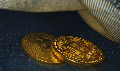 Golden bitcoin in the back pocket of jeans.