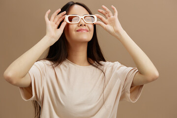 pretty woman in a beige T-shirt with glasses posing clothing fashion studio model