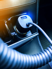 USB car charger connected to the car cigarette lighter.