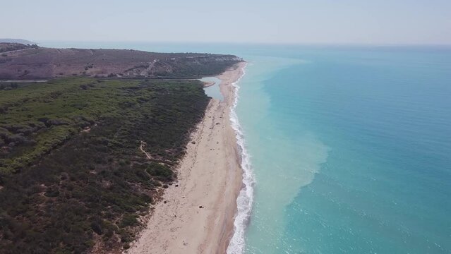 Aerial drone view of the Natural Reserve Foce del Fiume Platani and Capo Bianco in Sicily with turquoise sea and white limestone cliffs on a sunny summer day. Province of Agrigento near Eraclea Minoa.