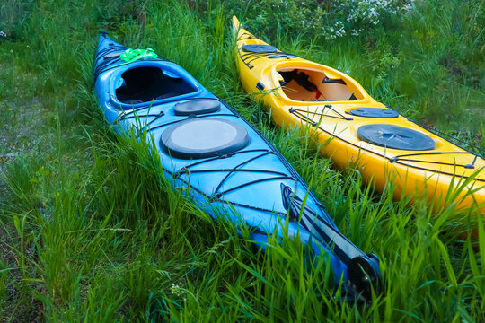 blue and yellow kayaks on the grass