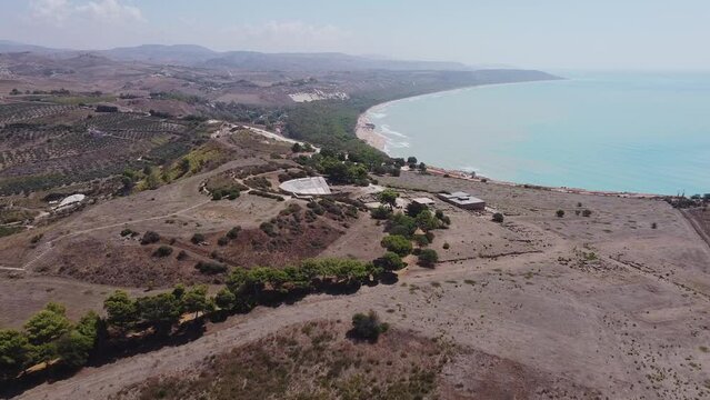 Aerial drone view of the Natural Reserve Foce del Fiume Platani and Capo Bianco in Sicily with turquoise sea and white limestone cliffs on a sunny summer day. Province of Agrigento near Eraclea Minoa.