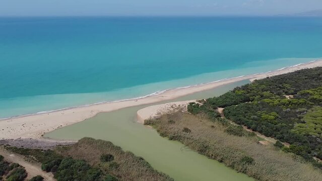 Aerial drone view of the Natural Reserve Foce del Fiume Platani and Capo Bianco in Sicily with turquoise sea and white limestone cliffs on a sunny summer day. Province of Agrigento near Eraclea Minoa.