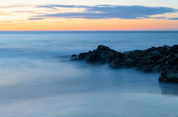 Wave breaker in the North Sea at sunset, Oostende (Ostend) beach, Belgium.