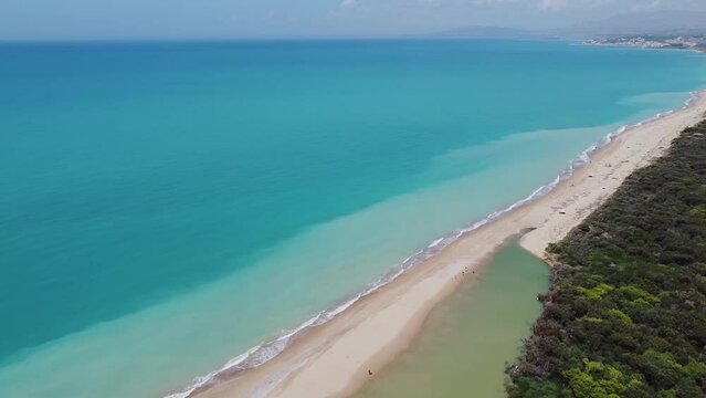 Aerial drone view of the Natural Reserve Foce del Fiume Platani and Capo Bianco in Sicily with turquoise sea and white limestone cliffs on a sunny summer day. Province of Agrigento near Eraclea Minoa.