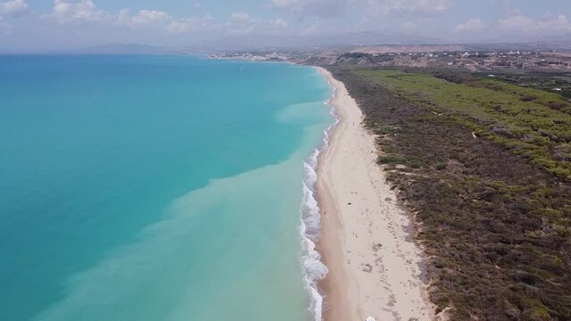 Aerial drone view of the Natural Reserve Foce del Fiume Platani and Capo Bianco in Sicily with turquoise sea and white limestone cliffs on a sunny summer day. Province of Agrigento near Eraclea Minoa.