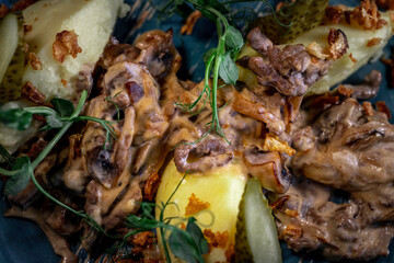 Beef stroganoff, goulash, with sauce and mushrooms, boiled potatoes.
National Russian dish of beef stroganoff with meat, boiled potatoes, mushrooms and fried onions.