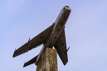 Monument to an old retro vintage airplane. Background with copy space