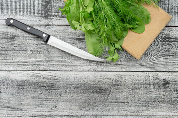 Diet. different products on wooden table, flat lay. Fresh herbs, green onions, spinach, dill, parsley and vegetables.