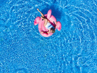 Beautiful woman in pool in hotel. Summer holidays, enjoying summer vacations during quarantine