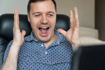 Excited guy feel euphoric receiving pleasant email message on laptop. Emotional man celebrating...