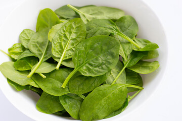 Spinach leaves on white background.