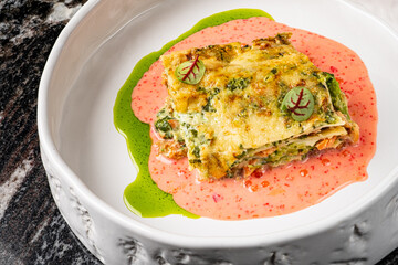 A piece of lasagna on a white plate