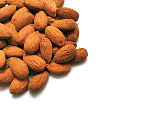 Golden almonds on the white background. Closeup of whole raw almonds