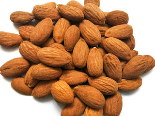 Golden almonds on the white background. Closeup of whole raw almonds