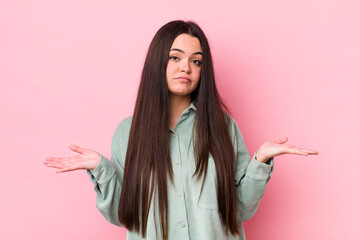 young adult woman feeling puzzled and confused, unsure about the correct answer or decision, trying...