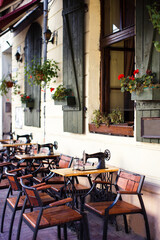 Sewing machines on tables and windows with flowers