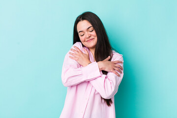 young adult woman feeling in love, smiling, cuddling and hugging self, staying single, being...