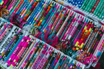 The stand with multicolored handmade bracelets with the different names.