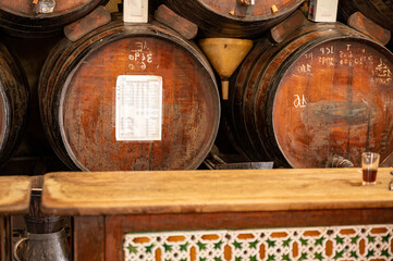 Tasting of different sweet wines from wooden barrels on old bodega in central part of Malaga,...