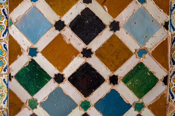 Ornamental medieval ceramic tiles of walls in Nasrid Palaces in the Alhambra palace Granada,...