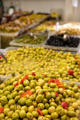 Assortment of pickled green olives on farmers market in Malaga, Andalusia, Spain