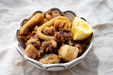 Spanish sea food, cripsy deep fried baby octopus, fish, calamari rings served with lemon