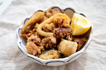 Spanish sea food, cripsy deep fried baby octopus, fish, calamari rings served with lemon