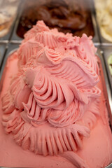 Assortment of colorful artisanal ice cream in refrigerator close up in Spain