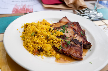 Andalusian cuisine, spicy cous-cous with grilled pork ham filet