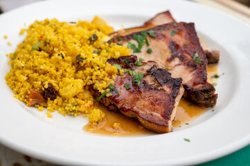 Andalusian cuisine, spicy cous-cous with grilled pork ham filet