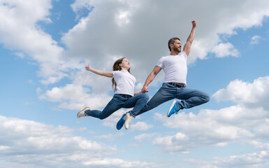 happy father and daughter jump in sky. family day